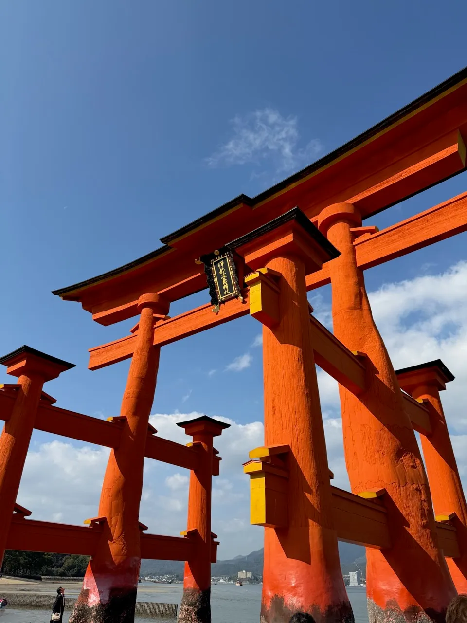 The giant vermillion floating torii gate of Itsukushima Shrine standing in the water at Miyajima