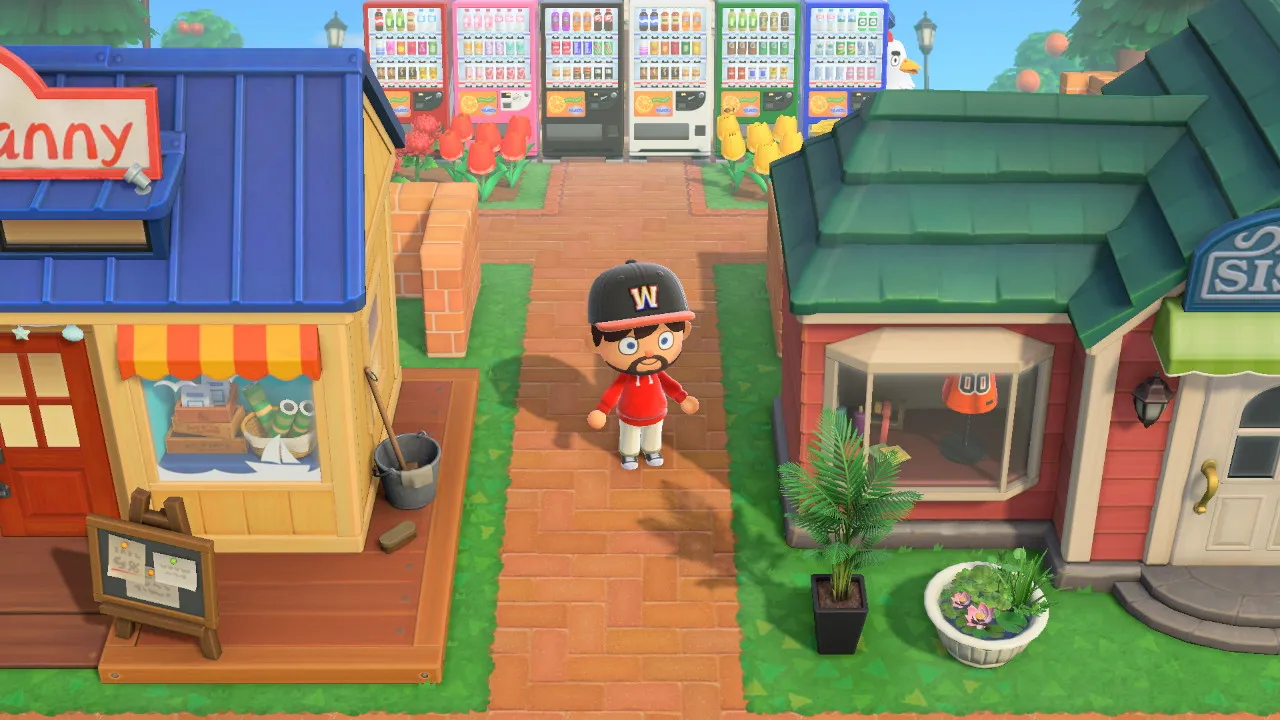 The "main street": Nook's Cranny and Able Sisters facing off across a row of vending machines, with a flag and tulip beds.