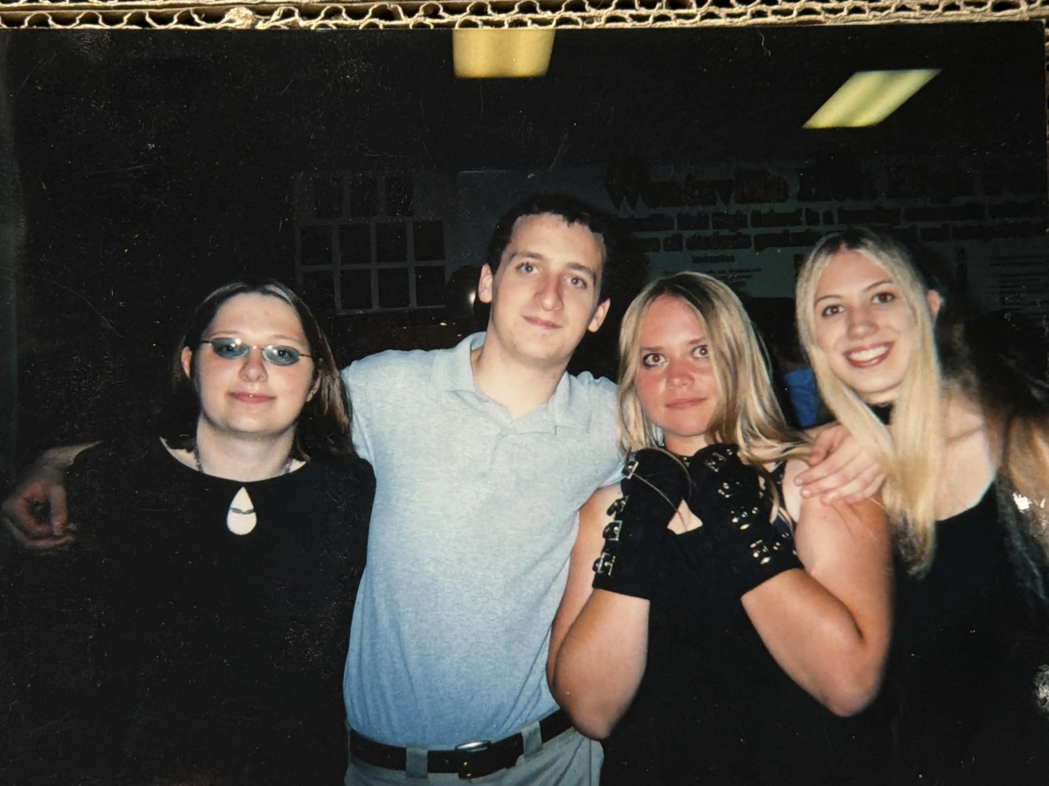 The four Dragon Siblings standing together, arms around each other: from left, McKenzie, me, April, and Diana.