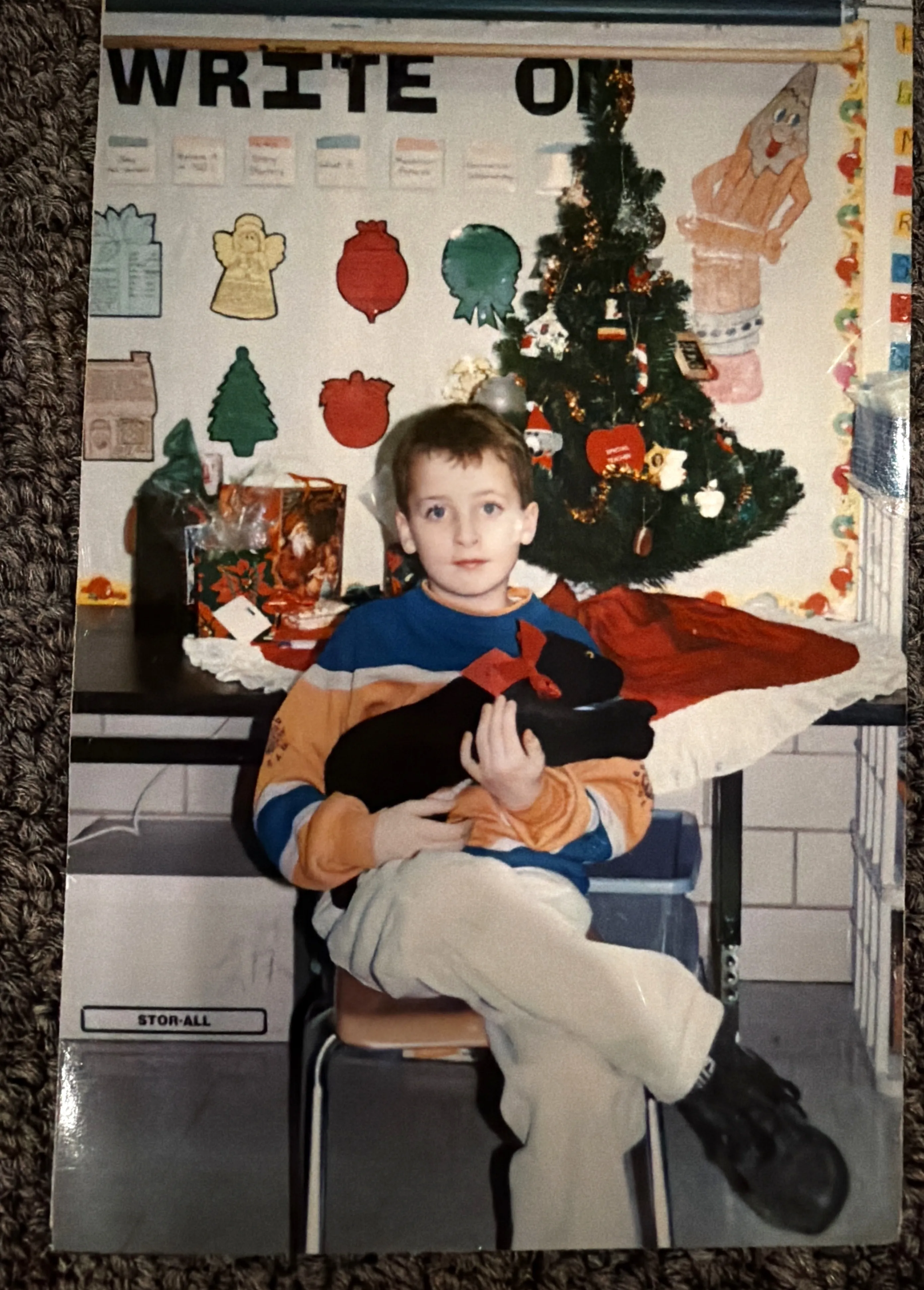 First grade, around Christmas 1994, holding our class's black panther