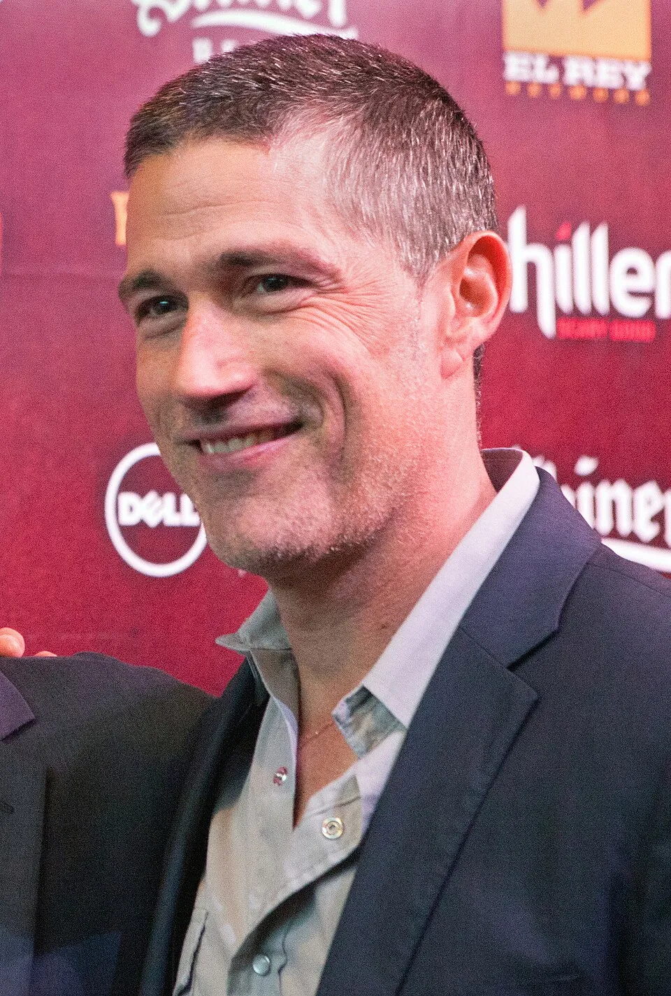 Matthew Fox, who played Jack Shephard on LOST, smiling at a red-carpet event.