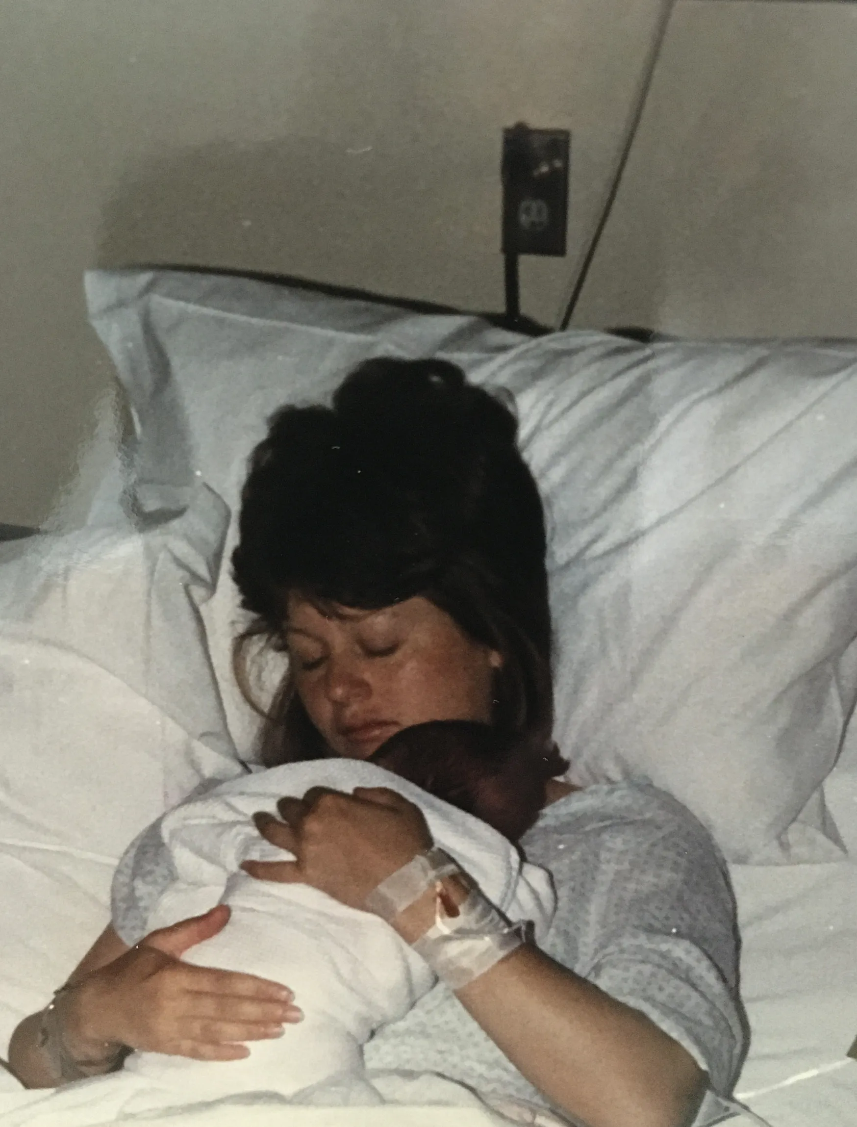 My mom holding me in her hospital bed at Missouri Baptist, the day I was born or just after