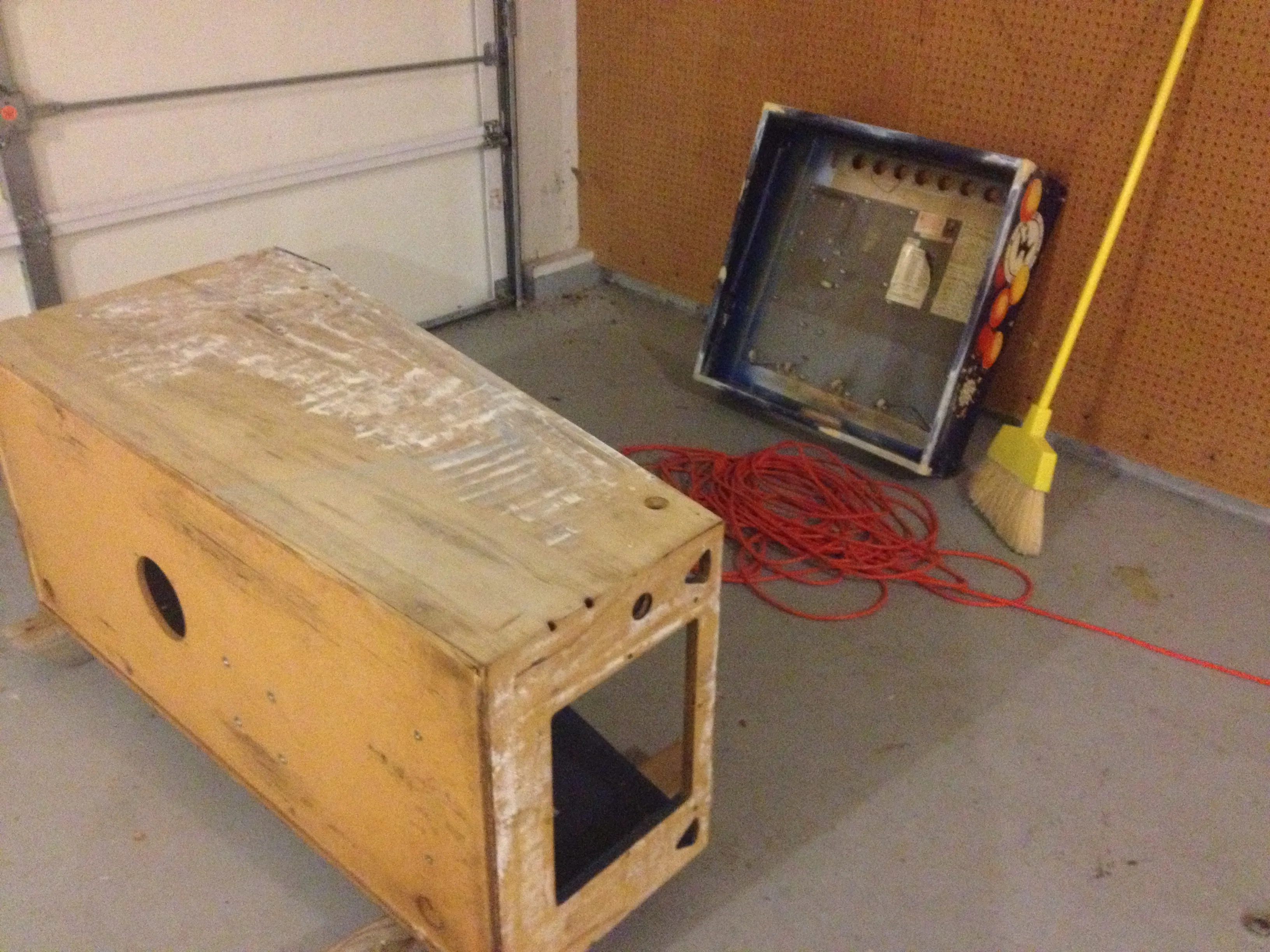 Halfway through sanding the cabinet, the head still wearing its old art
