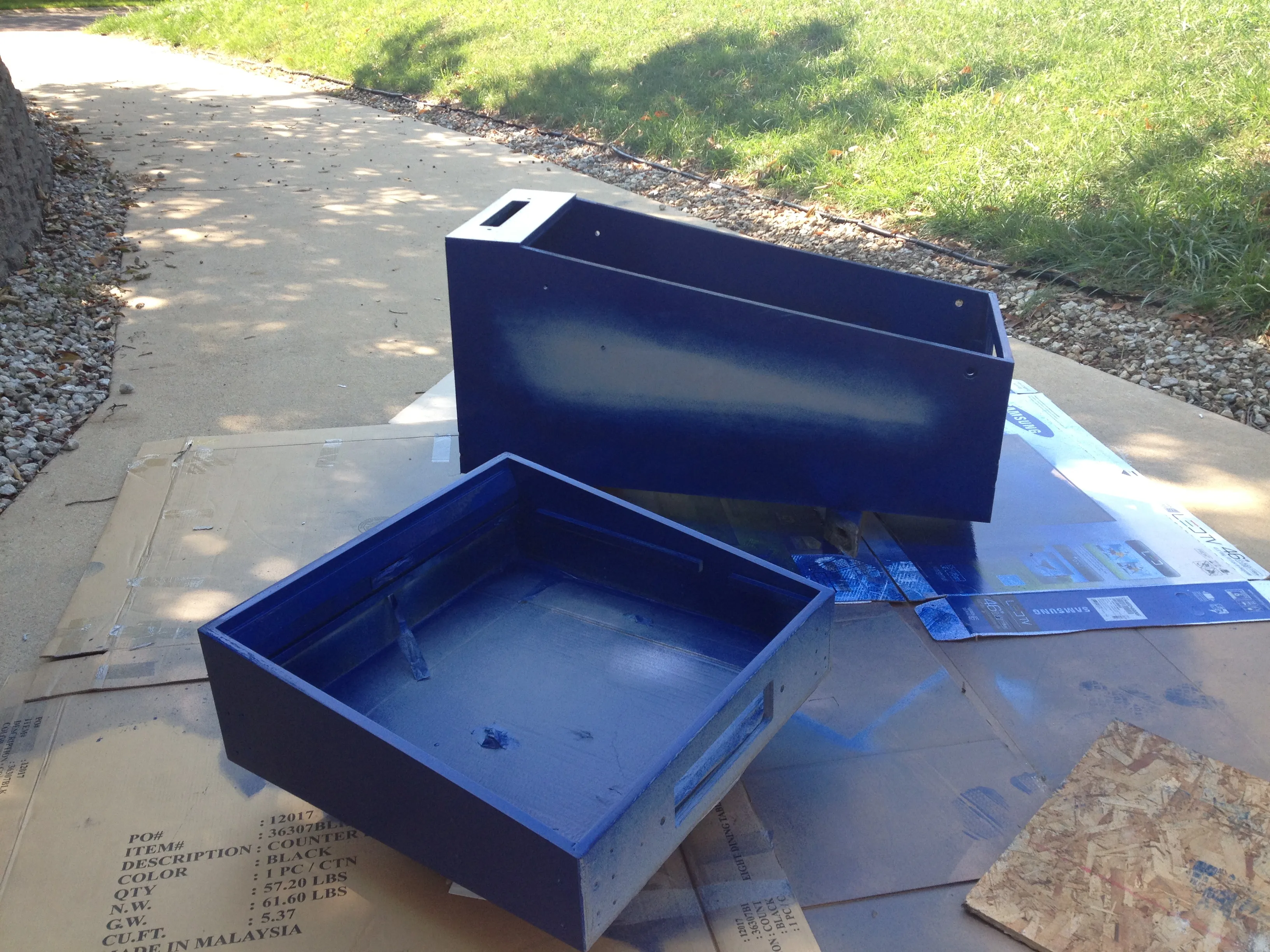 The freshly painted blue cabinet and head drying out in the driveway