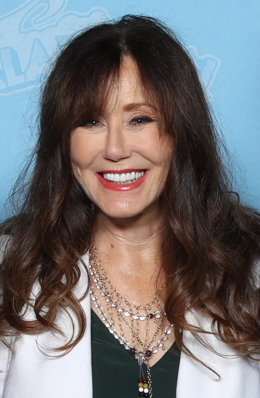 Mary McDonnell, who played President Laura Roslin, smiling at a convention appearance.