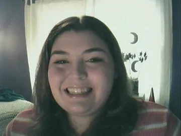 Sara, smiling into a webcam