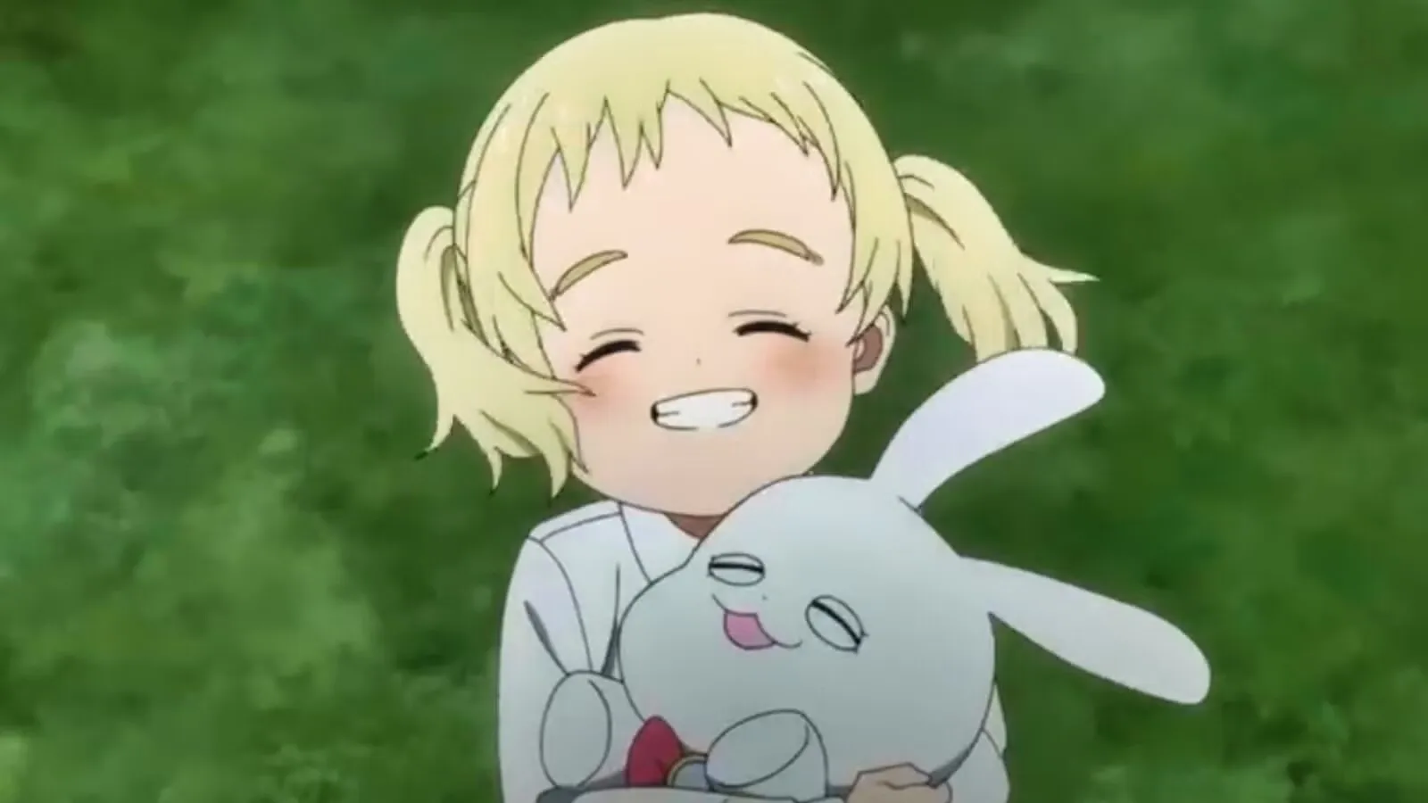 Conny smiling and hugging her stuffed bunny in the field.