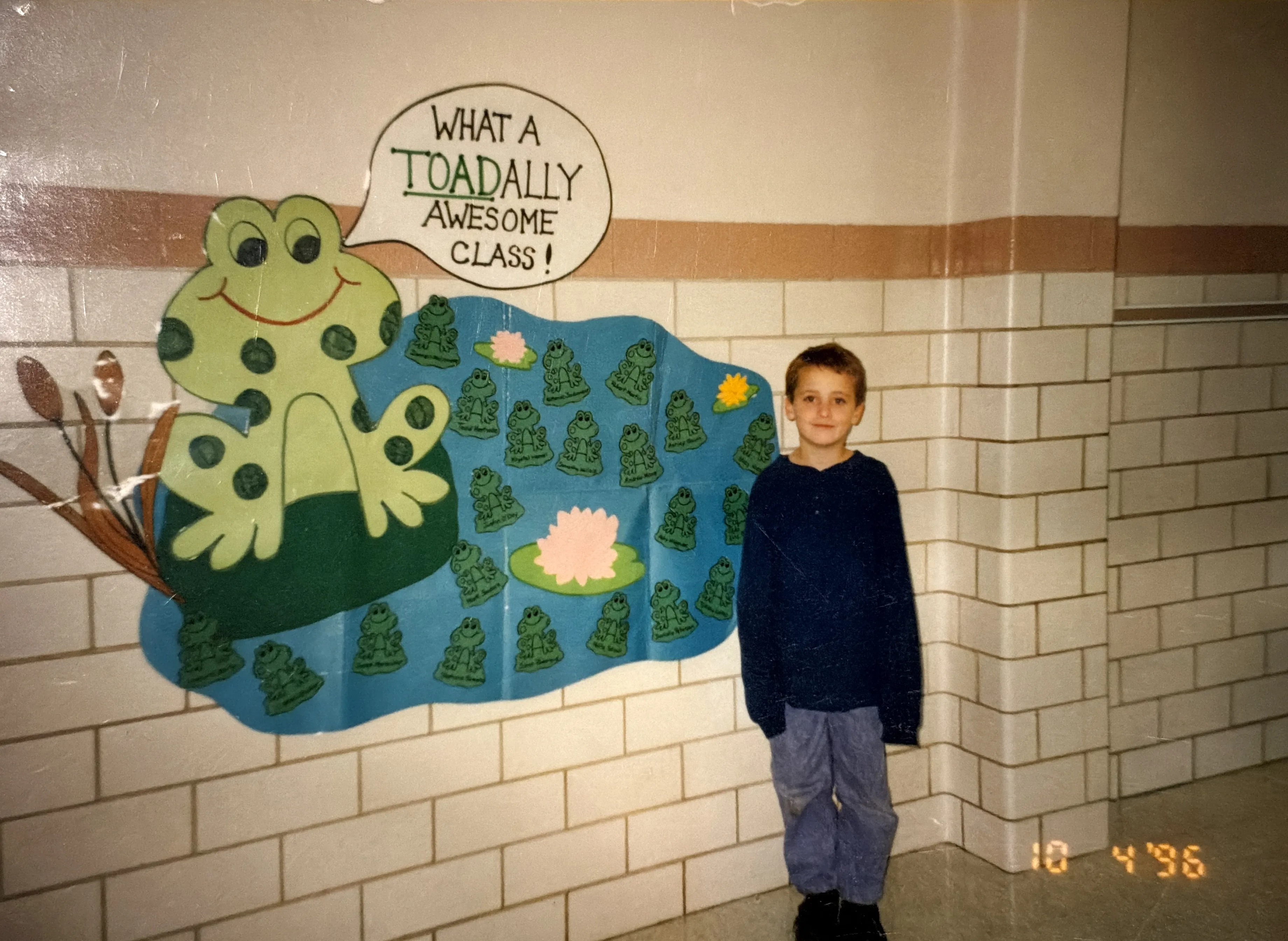 Me in third grade, next to my class's TOADALLY Awesome board, October 1996